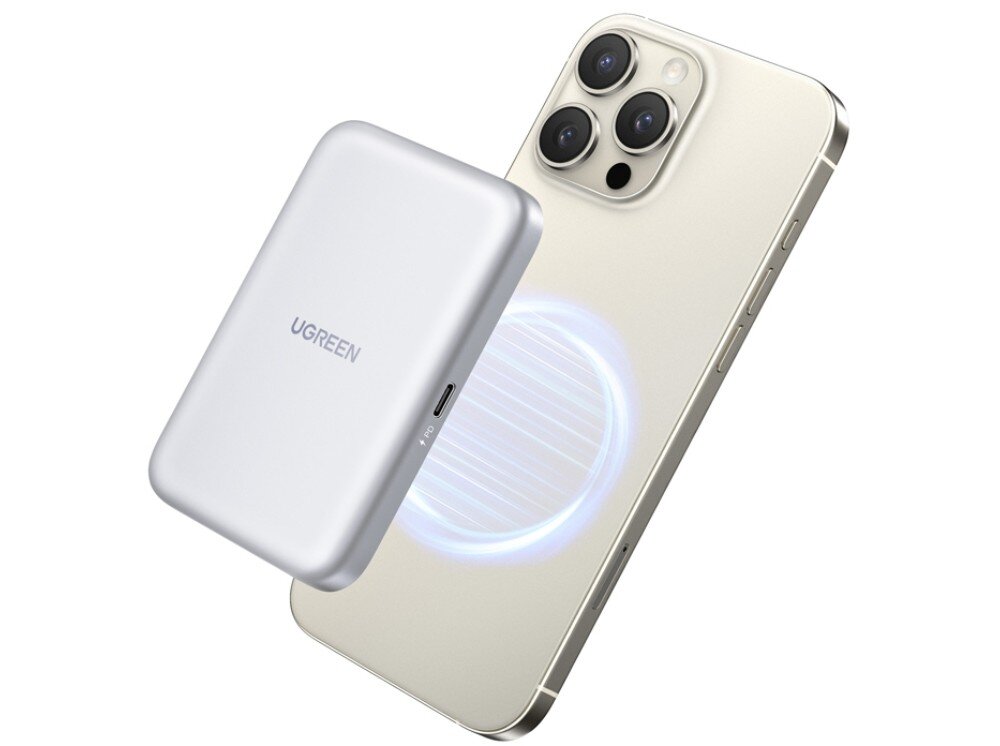 Obudowa dysku UGREEN D619 Srebrna obudowa unosząca się nad tyłem smartfona. Między urządzeniami widoczna jest błękitna, kolista poświata sugerująca połączenie magnetyczne