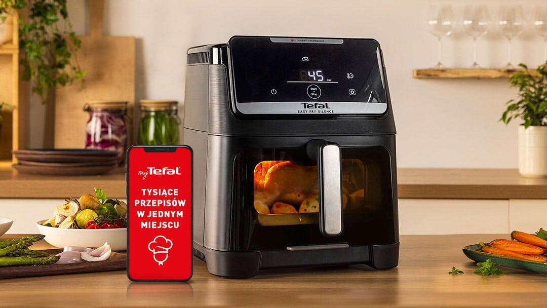 Frytkownicy TEFAL Easy Fry Silence EY8468 na kuchennym blacie, obok smartfon z aplikacją MyTefal.