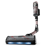 Odkurzacz pionowy z elastyczną rurą i przezroczystym pojemnikiem na kurz. Na głowicy znajdują się trzy niebieskie światła LED.