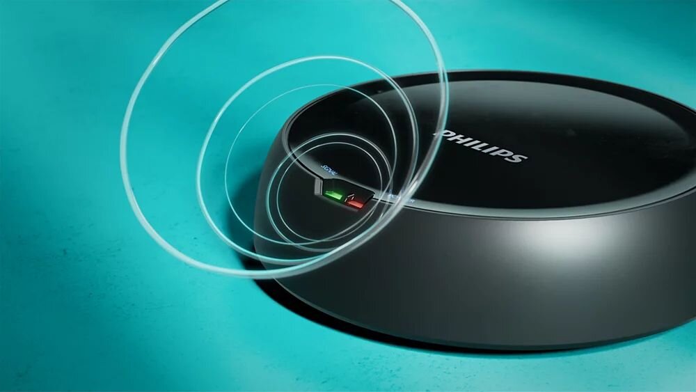 Słuchawki nauszne PHILIPS SHC5200M2/12, cyfrowe połączenie 2,4 GHz, zasięg 30 m, jednostka bazowa, nadajnik na turkusowym blacie