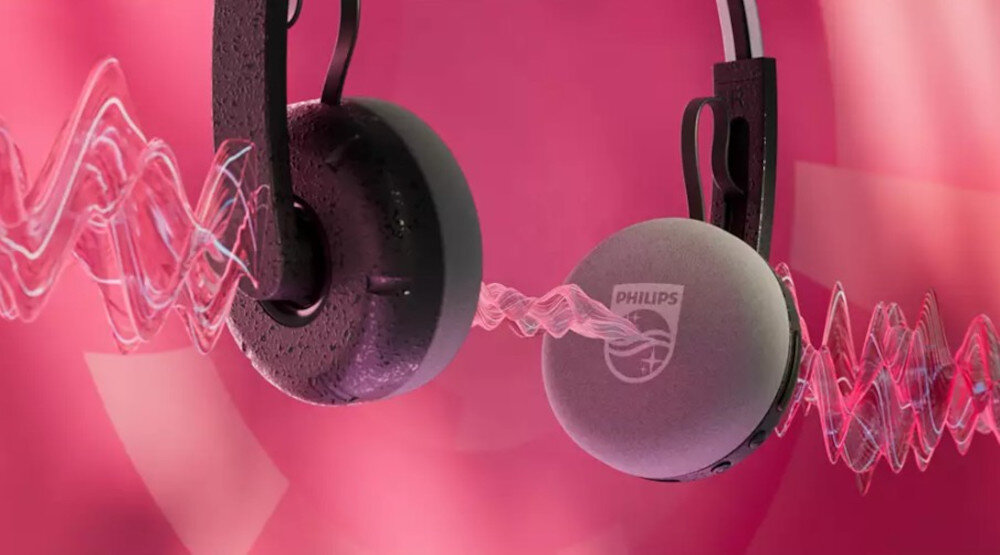 Słuchawki PHILIPS TAH2000BK/00 mikrofon redukcja szumów wyraźny głos, słuchawki po skosie na różowym tle, dźwięk przechodzący przez nauszniki