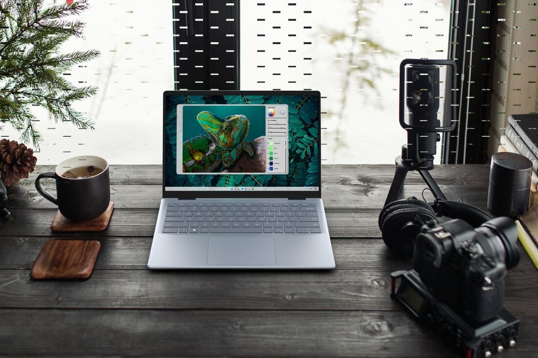 Laptop DELL Inspiron 5440 - Laptop DELL Inspiron 5440, aparat i roślina na drewnianym stole, tworzą harmonijną przestrzeń do pracy i relaksu. Intel Core Intel Iris Xe dysk SSD RAM DDR5