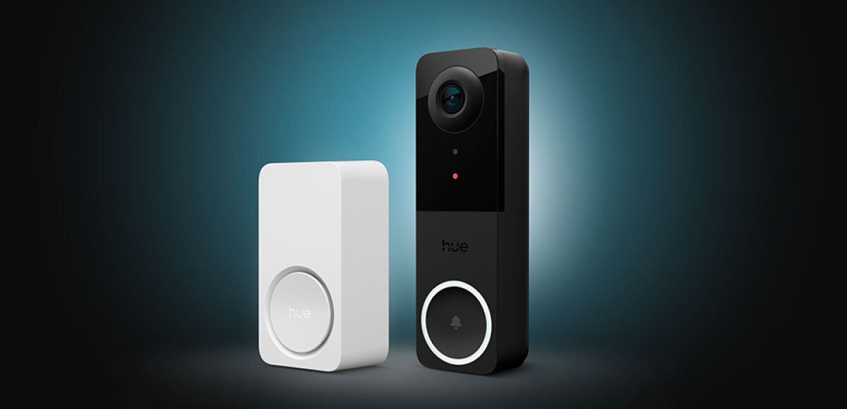 Dzwonek PHILIPS HUE, zintegrowany, błyskawicznie, powiadomienia, dom, Dwie urządzenia; czarny wideodomofon oraz biały sygnalizator Hue Secure na ciemnoturkusowym tle.