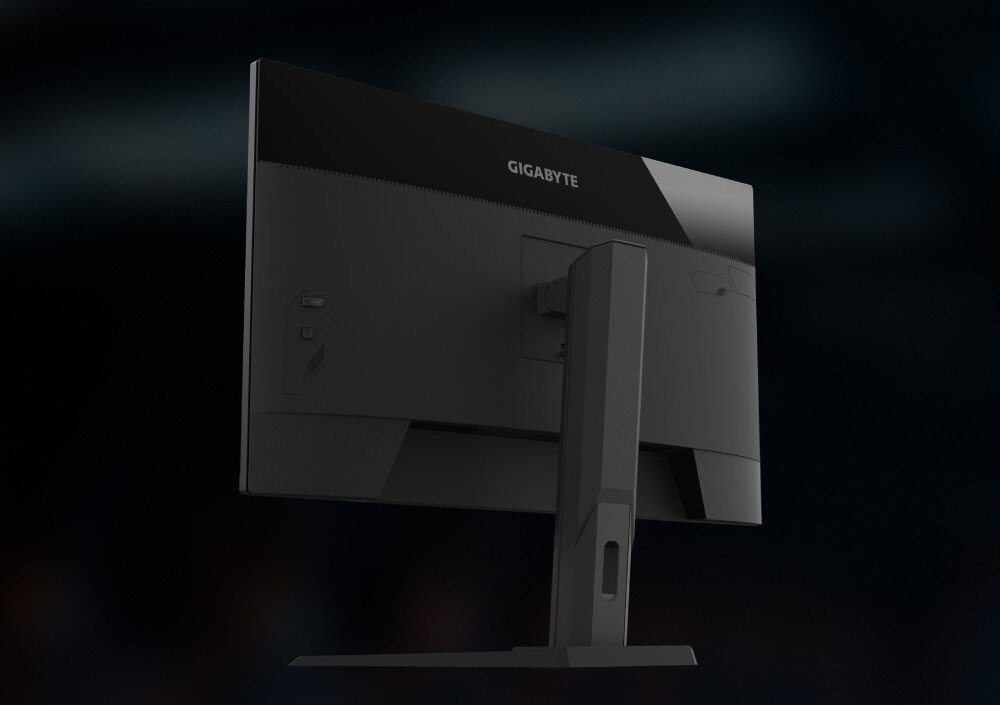 Monitor GIGABYTE M32UP Widok na tylną część obudowy monitora w czarnym kolorze z widoczną kolumną podstawy, głośniki, wyjście audio