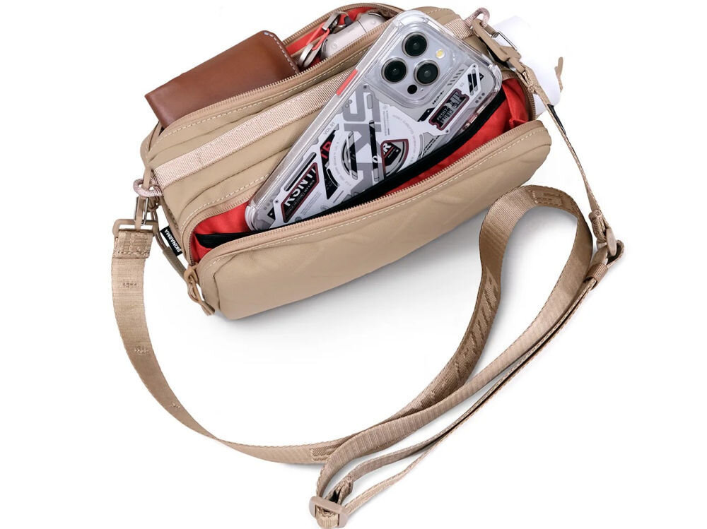 Torebka na telefon SKINARMA Juno Czarny prezentacja otwartej torebki na białym tle organizer z kieszeniami i miejscem na butelkę wodoodporny nylon komory zapinane na suwak funkcjonalność codzienne użytkowanie podróż