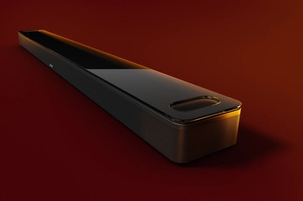 Soundbar BOSE Smart Ultra HDMI eARC kabel optyczny podłączenie telewizora, soundbar po skosie na czerwonym tle