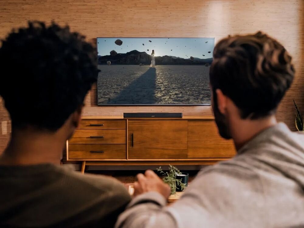 Soundbar BOSE Smart Dolby Atmos Bose TrueSpace 5.1 stereo dźwięk przestrzenny, soundbar stojący na komodzie w pomieszczeniu