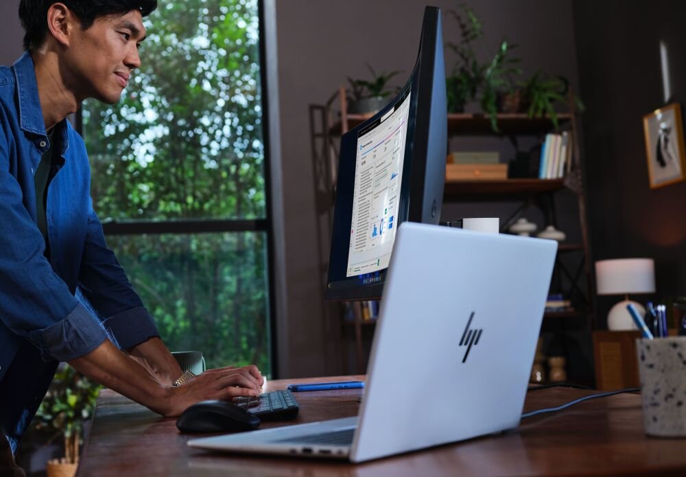 Laptop HP EliteBook 8 G1i stoi na biurku eksponując aluminiową obudowę – MIL-STD-810H grubość 16 mm waga 1,7 kg certyfikat wytrzymałości