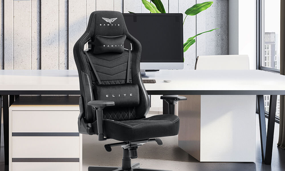 Fotel GAMVIS Elite 2.0 Pro XXL Czarny (białe elementy) prezentacja fotela w pokoju przy biurku monitor na biurku jasne biuro wielozadaniowość fotel biurowy gamingowy komfort