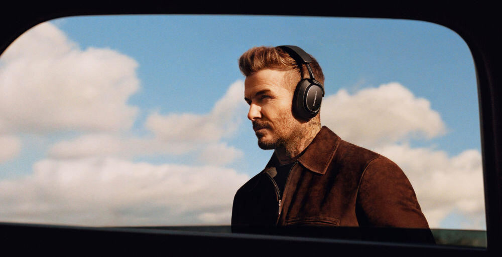 Słuchawki nauszne BOWERS & WILKINS Px8 S2 ANC 30h bateria szybkie ładowanie 7h odtwarzania, David Beckham z założonymi słuchawkami nausznymi