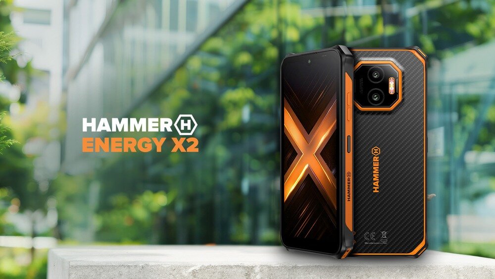 HAMMER ENERGY X2  - widok przodu i tyłu smartfona na tle miasta; ekran z motywem X, czarno-pomarańczowa obudowa, logo produktu obok.