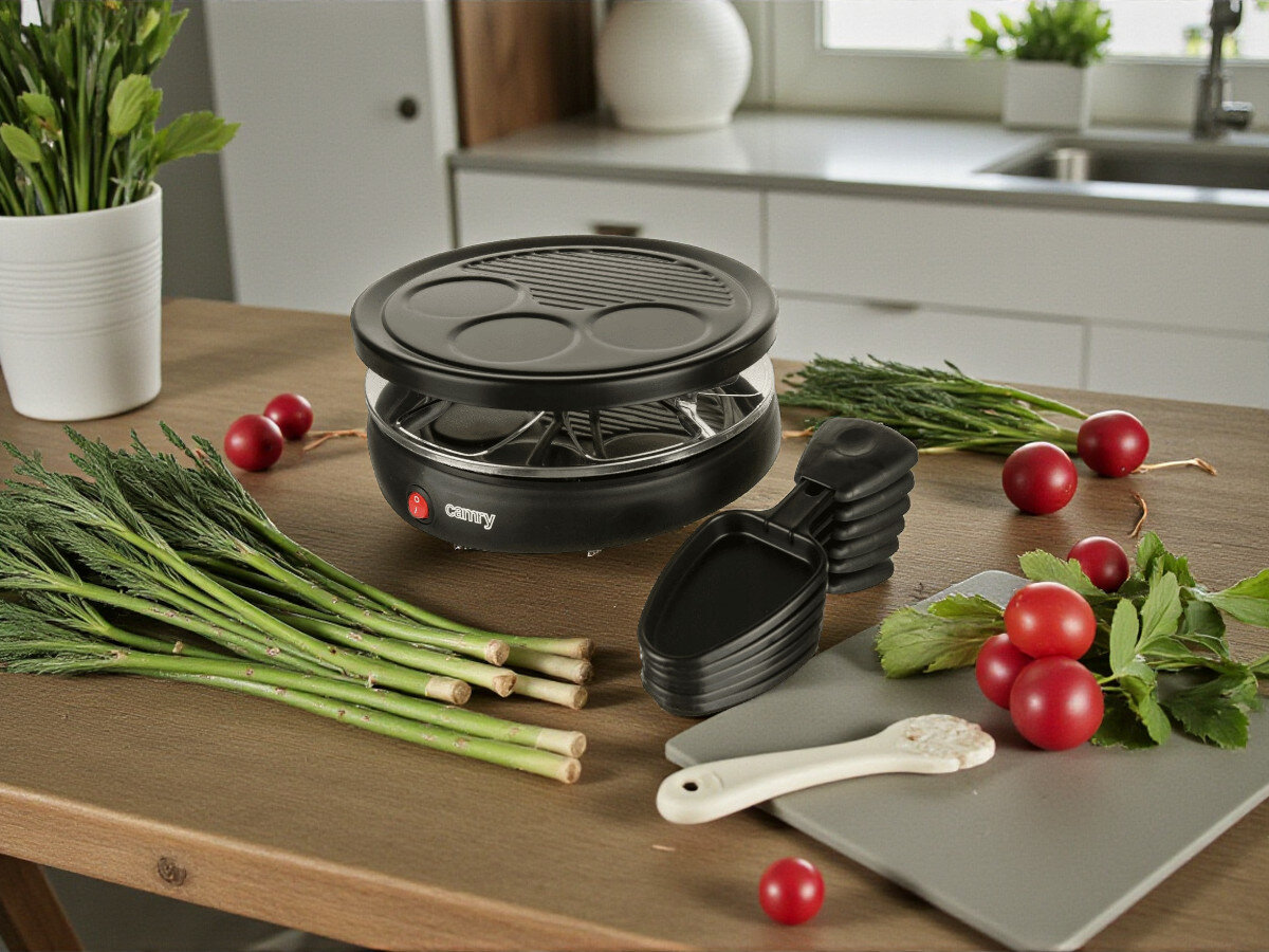 Grill elektryczny CAMRY CR 6606, mięso, warzywa, sery, przekąski, Grill raclette z jedzeniem na jasnym blacie kuchni