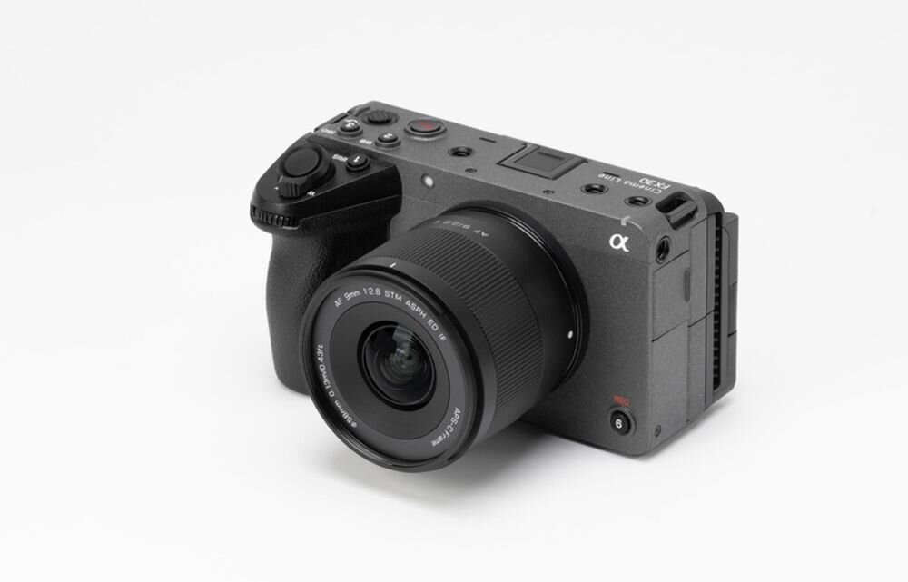 Aparat fotograficzny z zamontowanym obiektywem, na obiektywie widoczny napis \'AF 9mm f/2.8 STM ASPH\'.