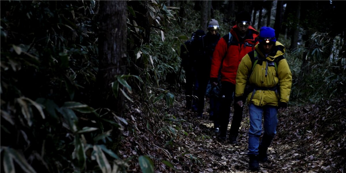 Latarka czołowa HAMA HL500-C, tryby, ściemnianie, elastyczność, komfort, Grupa turystów z czołówkami idzie nocą przez las