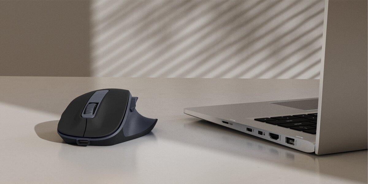 Mysz HAMA WM-500 Czarny Bezprzewodowa mysz ergonomiczna Hama w kolorze antracytowym na biurku obok laptopa.