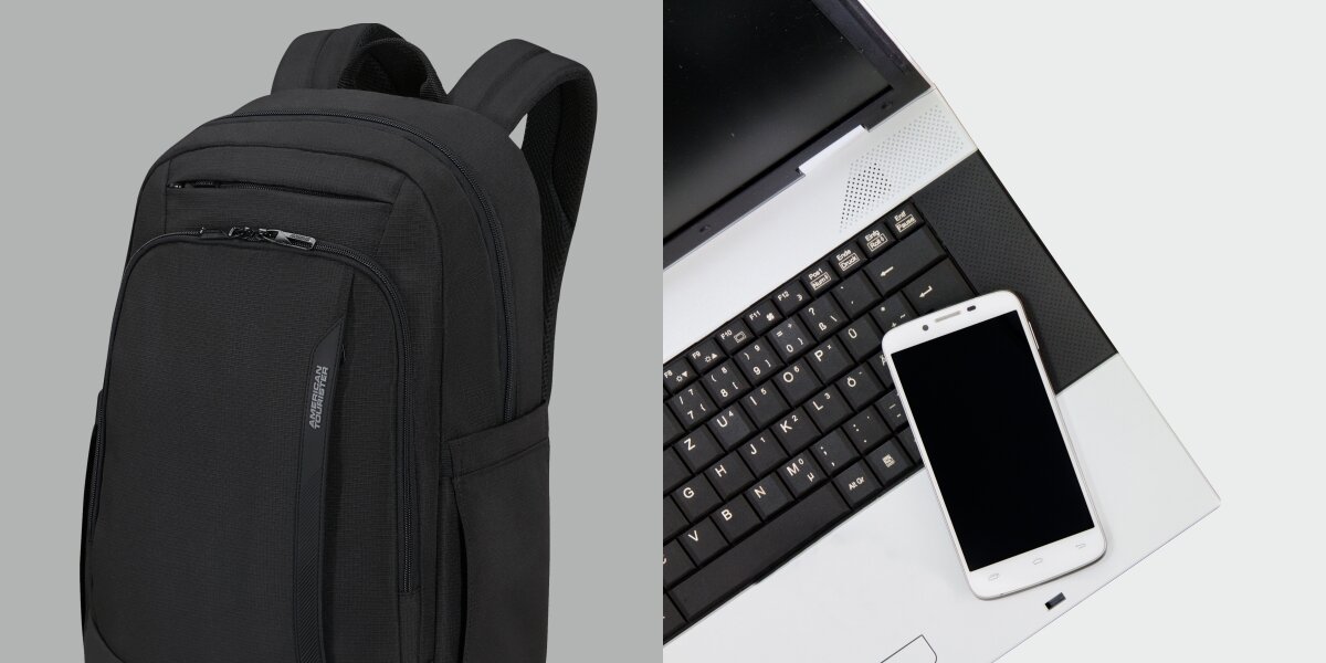 Plecak na laptopa AMERICAN TOURISTER Urban Groove 155519-1041 15.6 cala Czarny Zbliżenie na przednią część czarnego plecaka z logo oraz smartfon leżący na klawiaturze laptopa, sugerujący przeznaczenie na elektronikę