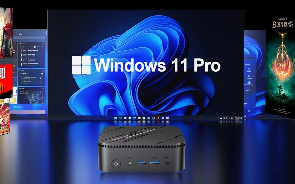 Komputer BLACKVIEW MP100 Pro Mały czarny komputer ustawiony przed dużym ekranem z niebieskim tłem i napisem 'Windows 11 Pro', po bokach widoczne plakaty gier i fragmenty interfejsu systemu, system