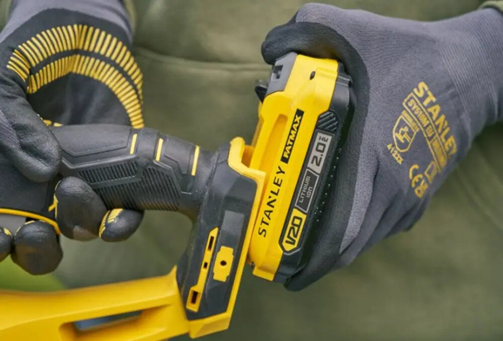 Nożyce do żywopłotu STANLEY SFMCHT650B-XJ 500mm 20V akumulatorowe osoba trzyma nożyce w dłoniach wkłada akumulator na miejsce akumulator z serii STANLEY Fatmax V20 brak efektu pamięci niskie samorozładowanie pełna swoboda ruchu pracy w dowolnym miejscu ogrodu wspólny system zasilania STANLEY Fatmax V20 jeden akumulator w wielu narzędziach