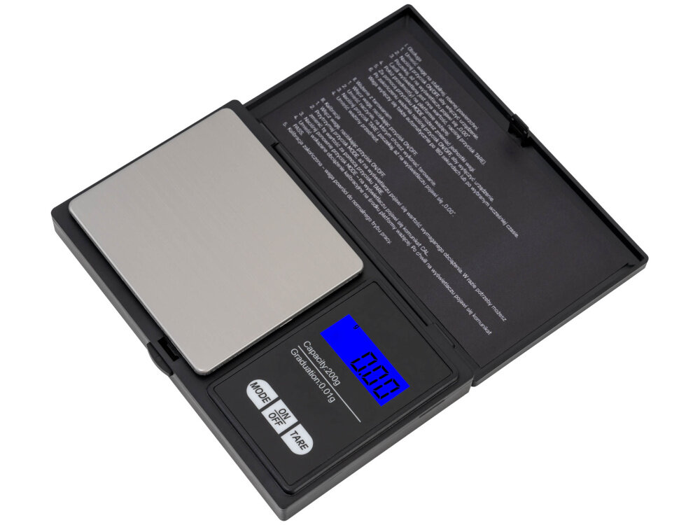 Waga jubilerska z wyświetlaczem LCD pokazującym wartość 0.00 g. Na obudowie widoczne są przyciski \'MODE\', \'ON/OFF\' i \'TARE\'.