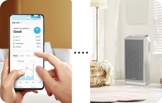 Smartfon wyświetlający dane o jakości powietrza obok oczyszczacza w jasnym pokoju.