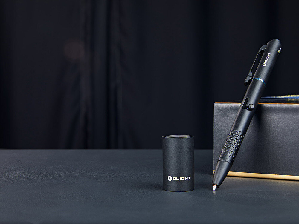 Latarka OLIGHT O'pen Glow OL001720 Czarny, pisanie, oświetlenie, laser, prezentacje, Długopis O’Pen Glow obok magnetycznej ładowarki