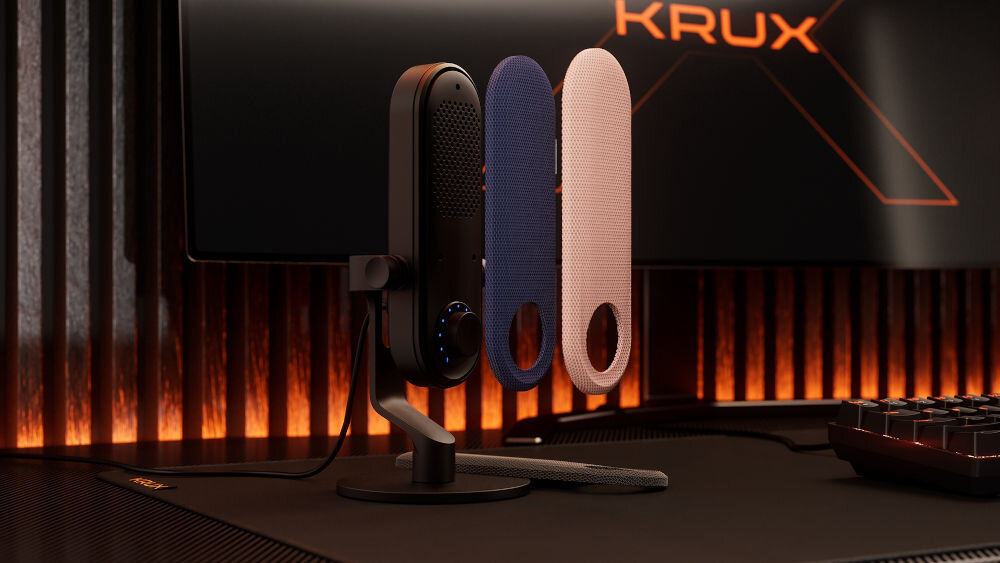Mikrofon KRUX Pin KRXC018 Kardioidalny Czarny Mikrofon KRUX Pin w czarnym kolorze, stojący na biurku gamingowym, z dwoma wymiennymi panelami (niebieskim i różowym) uniesionymi obok, na tle monitora z logo KRUX możliwość personalizacji wymienne panele dopasowanie mikrofonu do stanowiska pokaż swój styl