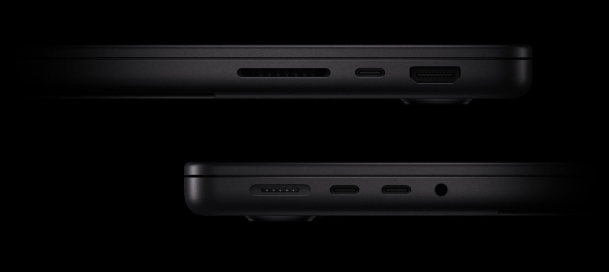 APPLE MacBook Pro MacBook Pro trzy porty Thunderbolt 4 lub 5, złącze HDMI, port MagSafe 3, gniazdo SDXC wejście słuchawkowe dyski, aparaty, monitory zewnętrzne - Zbliżenie na porty boczne laptopa na czarnym tle
