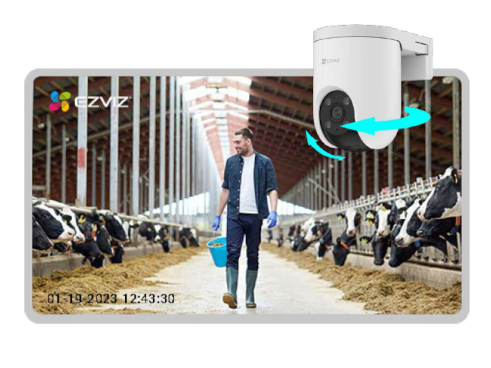 Kamera EZVIZ H8C 4G 2K - Automatyczne śledzenie ruchu, mężczyzna przechadzający się po oborze z krowami, na pierwszym planie kamera pod skosem
