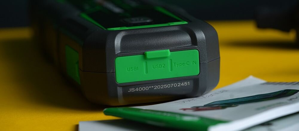 Urządzenie rozruchowe NAVITEL JS4000 magazyn energii USB-A USB-C ładowanie, osoba jadąca samochodem, urzadzenie po skosie