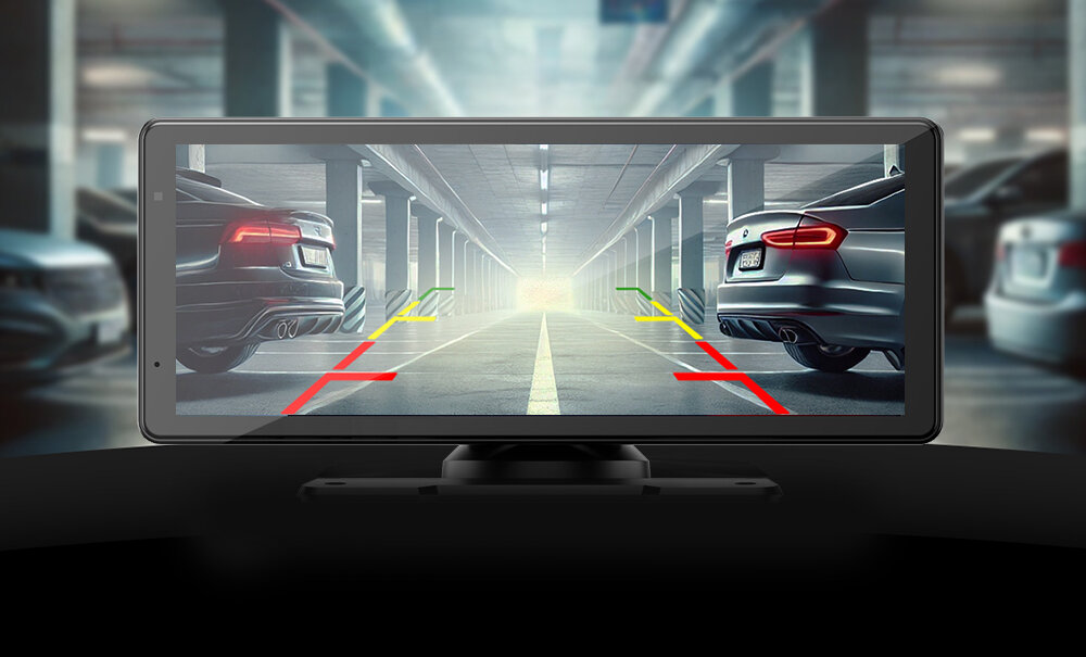 Obraz przedstawia ekran samochodowego tabletu multimedialnego z widokiem na parking podziemny. Na ekranie widoczne są linie pomocnicze w kolorach czerwonym, żółtym i zielonym.