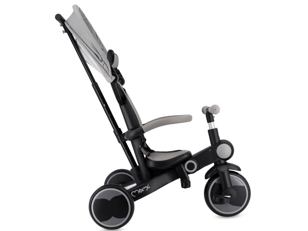 Rowerek trójkołowy MOMI Solivia 4w1 Opony Eva Szary rączka rowerek na białym tle widoczny z boku złożony daszek pięciopunktowe pasy z możliwością demontażu pałąk funkcja wolnej kierownicy kontrola nad jazdą regulowany daszek chroni przed słońcem możliwość jego całkowitego zdjęcia komfort dziecka