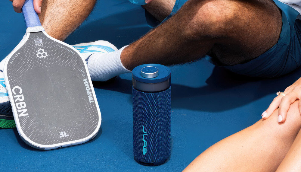 Głośnik JLAB Go Party wodoszczelny IP56, odporny na wodę, głośnik stojący na ziemi obok siedzących osób