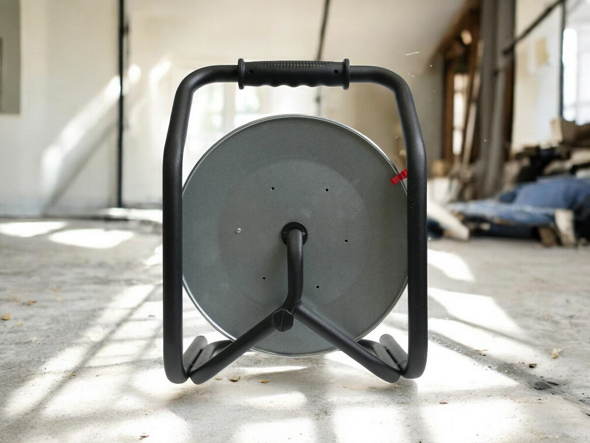 Przedłużacz bębnowy BORBY BY-02-36553 (40 m), ochrona, wyłącznik, IP44, wygoda, przedłużacz od tyłu pionowo frontem na wprost, w tle trwająca prace remontowo-budowlane