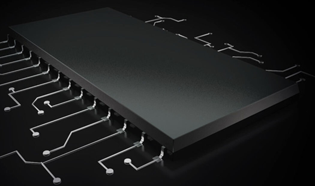 Obraz przedstawia czarny, prostokątny element elektroniczny na ciemnym tle, z którego wychodzą białe linie przypominające ścieżki obwodu drukowanego.