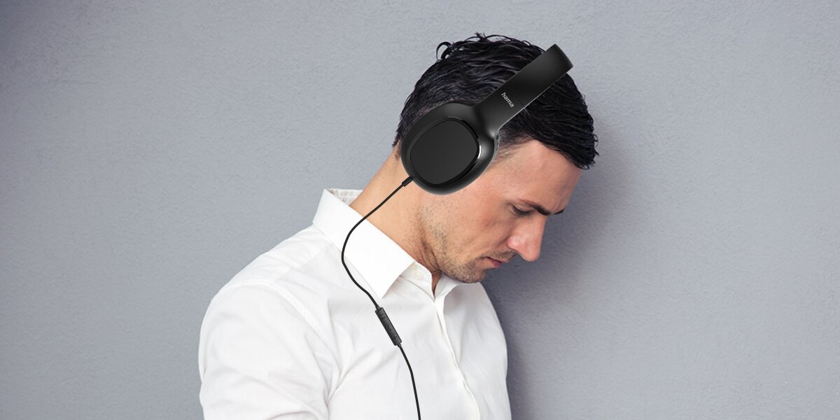 Słuchawki nauszne HAMA Fun C  Mężczyzna w białej koszuli korzystający ze słuchawek nagłownych Hama z mikrofonem na kablu, idealnych do pracy biurowej i wideokonferencji.