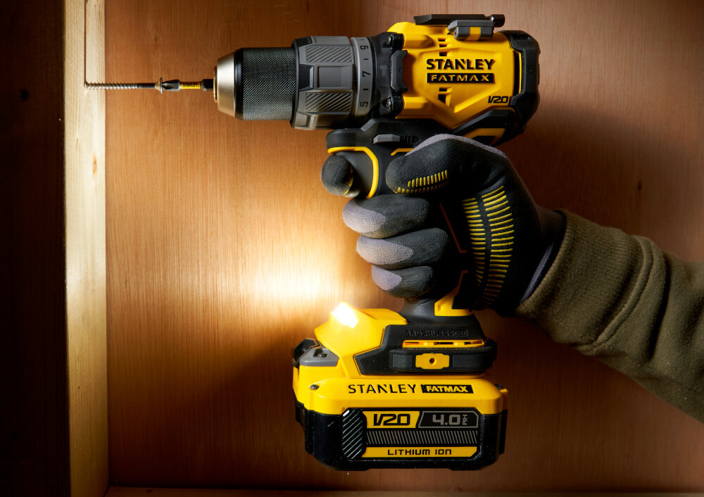 Zestaw elektronarzędzi STANLEY Fatmax SFMCK211D2T-QW pomieszczenie osoba trzyma wiertarko-wkrętarkę w dłoni włączona dioda LED oświetlenie LED widoczność w słabo oświetlonych miejscach magnetyczny uchwyt na bity wskaźnik naładowania akumulatora