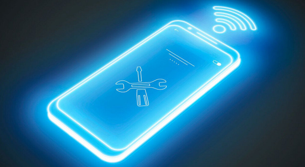 PŁYTA SIEMENS ED81AHWB1E 7.jpg przedstawia futurystyczną, świecącą na niebiesko grafikę smartfona z ikoną klucza i śrubokręta na ekranie, symbolizującą funkcje serwisowe lub diagnostykę. Nad telefonem widoczny jest znak Wi‑Fi, co sugeruje zdalną, bezprzewodową pomoc techniczną zdalna diagnostyka Home Connect serwis Siemens online inteligentna płyta indukcyjna szybka naprawa AGD wsparcie techniczne smart kuchnia