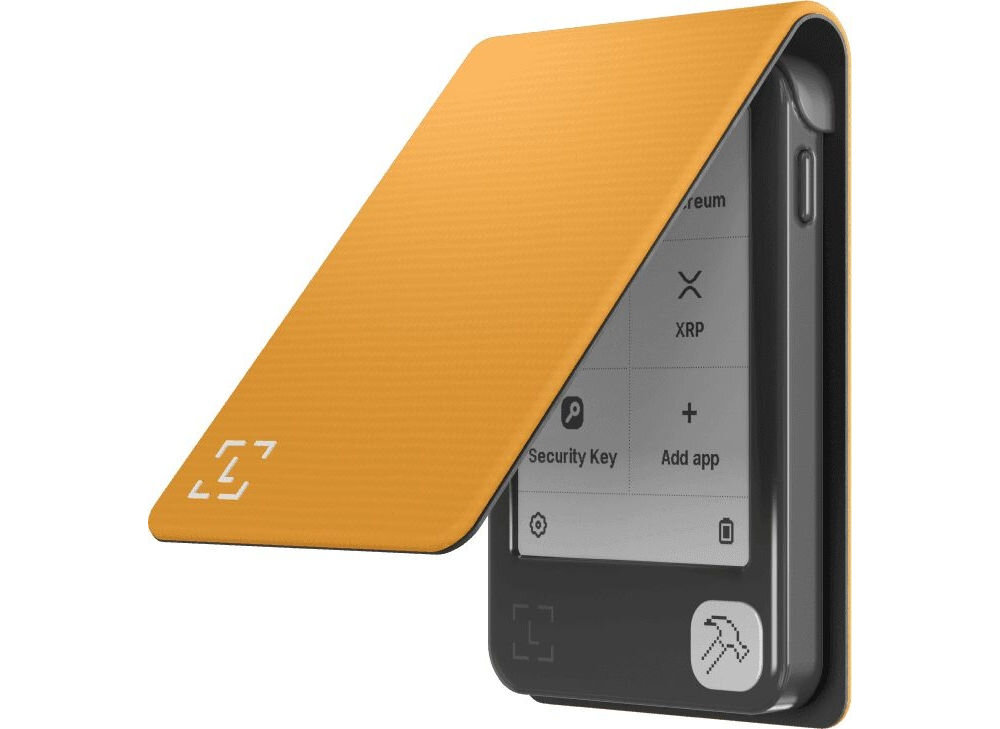 Etui LEDGER Nano Gen5 Magnet Folio Bakłażanowy Portfel sprzętowy do kryptowalut w otwartym, jaskrawo-pomarańczowym, gładkim etui z klapką. Na ekranie widoczne opcje interfejsu urządzenia (np. Ethereum, XRP, Add app, Security Key).