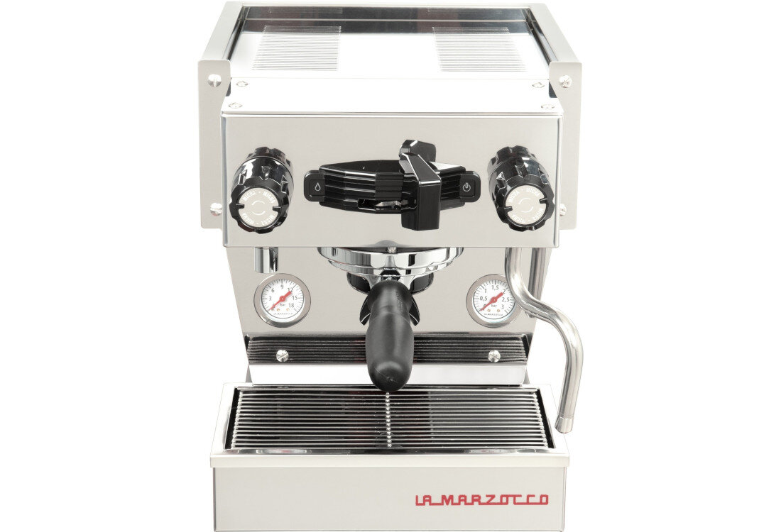 Stalowy ekspres do kawy z dwoma pokrętłami, manometrami i dyszą parową. Na dole widoczne jest logo \'LA MARZOCCO\'.