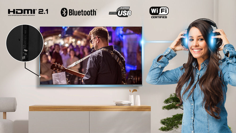 Telewizor JVC LT-50VGQ750P HDMI USB Bluetooth WiFi złącza dostęp, telewizor zawieszony na ścianie, osoba z założonymi słuchawkami nausznymi