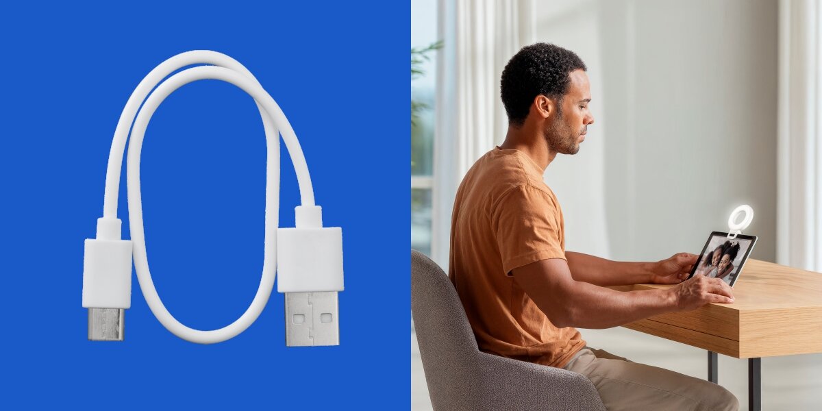 Lampka pierścieniowa LED HAMA To Go 4674 Biały kabel USB do ładowania lampy selfie oraz mężczyzna używający tabletu z doświetleniem LED podczas pracy przy biurku.