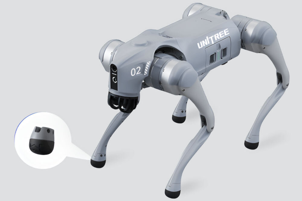Nakładka na stopę UNITREE Go2 Foot Pad Render czworonożnego, szarego robota Unitree GO2. W kółku widoczne jest powiększenie czarnej, gumowej stopki z bieżnikiem, która jest przymocowana do nogi robota.
