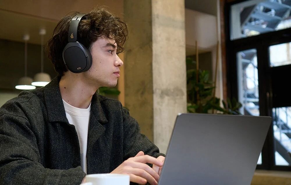Słuchawki nauszne EDIFIER W80 65 godzin pracy 40 godzin z ANC szybkie ładowanie USB-C 15 minut 10 godzin słuchania, osoba z założonymi słuchawkami nausznymi