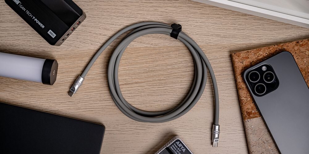 Kabel Newell USB-C - USB-C 100 W, 2 m, silikonowy, na drewnianym blacie pośród sprzętów, które można nim naładować
