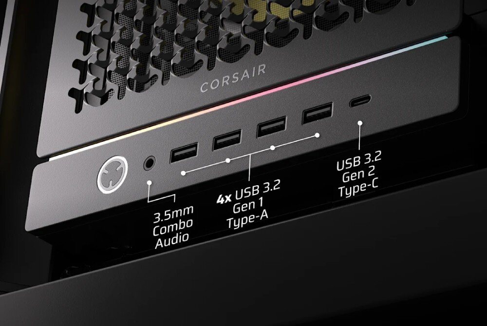 Obudowa CORSAIR Frame 5000D RS ARGB Zbliżenie na dolny panel portów zewnętrznych obudowy. Od lewej znajduje się okrągły przycisk zasilania, gniazdo audio 3.5 mm combo, cztery porty USB 3.2 Gen 1 typu A oraz jeden port USB 3.2 Gen 2 typu C