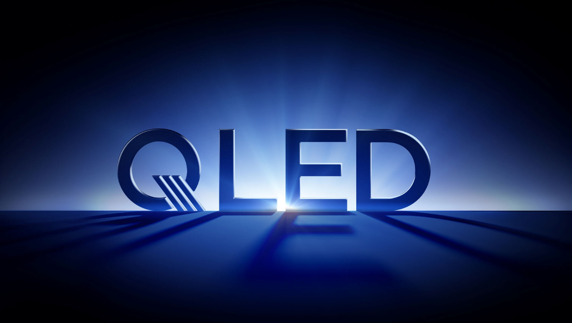 Logo technologii QLED w niebieskim świetle symbolizujące wysoką jakość kolorów i jasności obrazu.