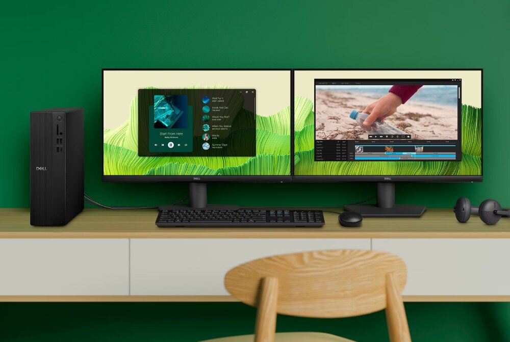 Komputer DELL Slim ECS1250 stanowisko pracy z dwoma monitorami wyświetlającymi odtwarzacz muzyki oraz program do edycji wideo, na biurku znajduje się również wąska obudowa komputera, klawiatura, myszka i słuchawki, porty, złącza