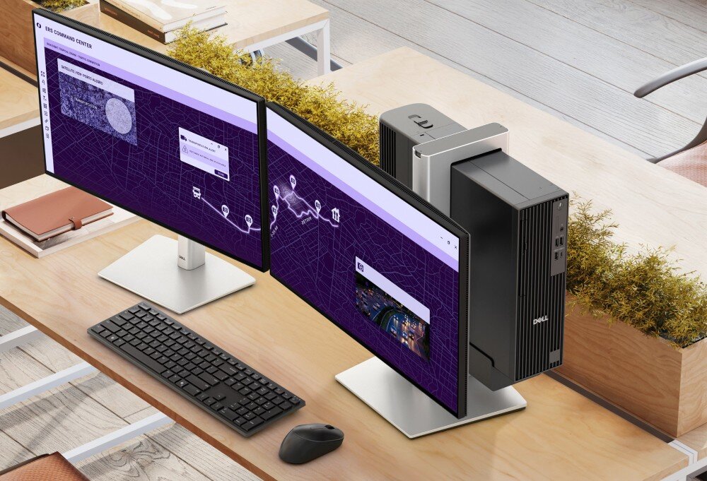Komputer DELL Pro Slim Plus QBS1250 Widok z góry na biurko z dwoma monitorami przymocowanymi do uchwytu, za którymi zamontowano pionowo komputer w czarnej obudowie, procesor, rdzenie, wydajność