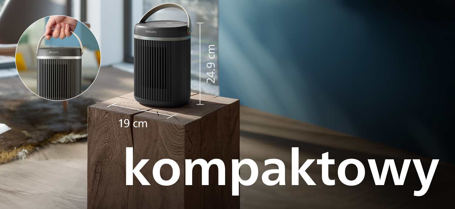 Czarny grzejnik ceramiczny z uchwytem, umieszczony na drewnianym bloku, z wymiarami 24.9 cm wysokości i 19 cm szerokości. Na obrazie widoczny jest napis \'kompaktowy\'.