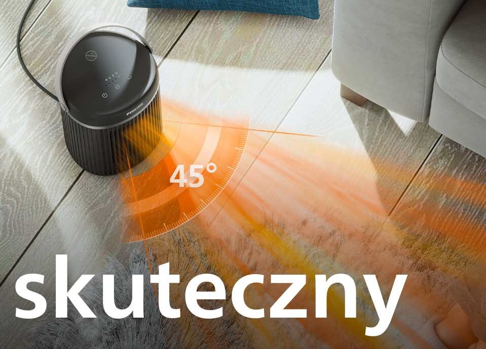 Na podłodze stoi czarny grzejnik ceramiczny z wyświetlaczem dotykowym, emitujący ciepło pod kątem 45 stopni. Na obrazie widoczny jest napis \'skuteczny\'.
